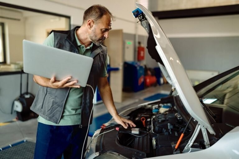 auto-repairman-using-laptop-whil