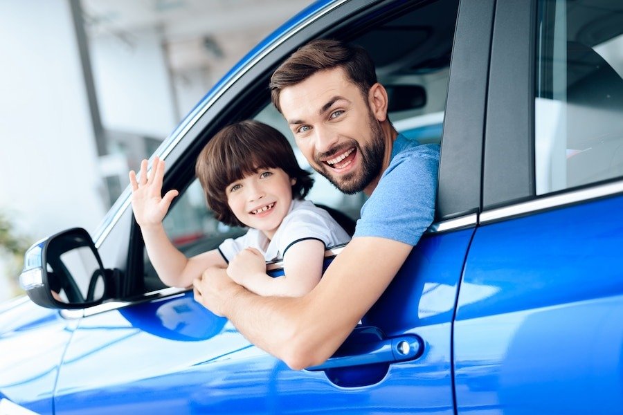 dad-son-look-out-car-window-smil