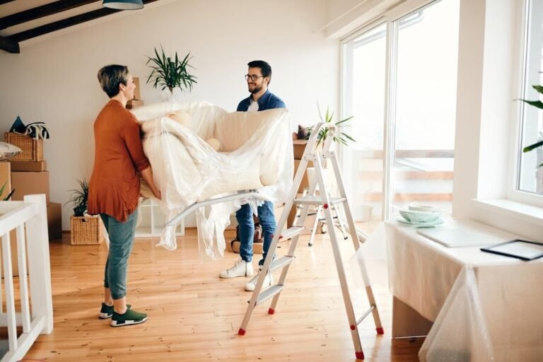 happy-couple-bringing-sofa-their