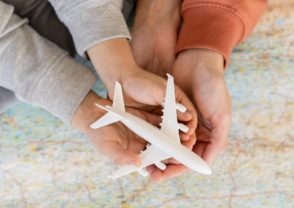 mother-child-home-holding-airplane-figurine-top-map